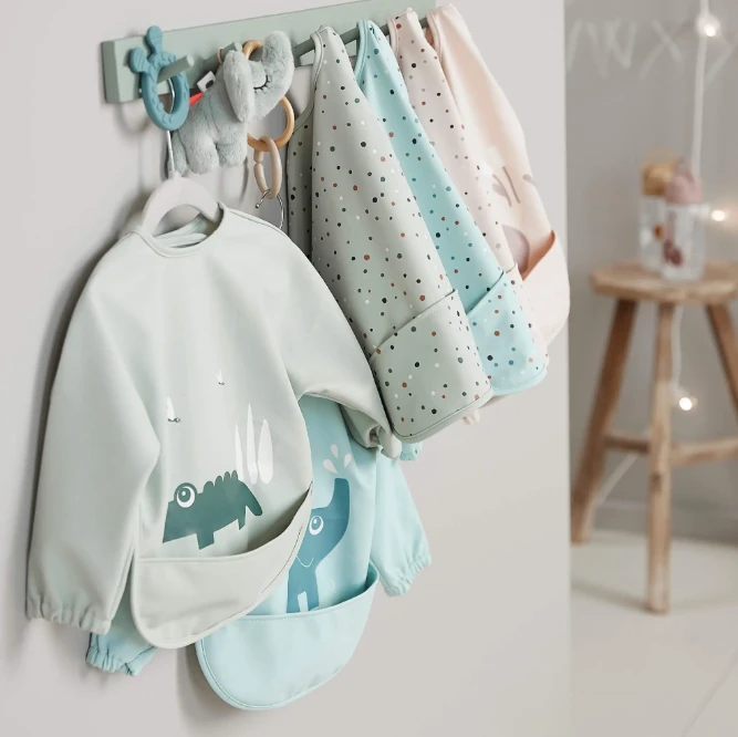 Done By Deer Sleeved Pocket Bib VARIOUS COLOURS 1 Done By Deer Sleeved Pocket Bib VARIOUS COLOURS